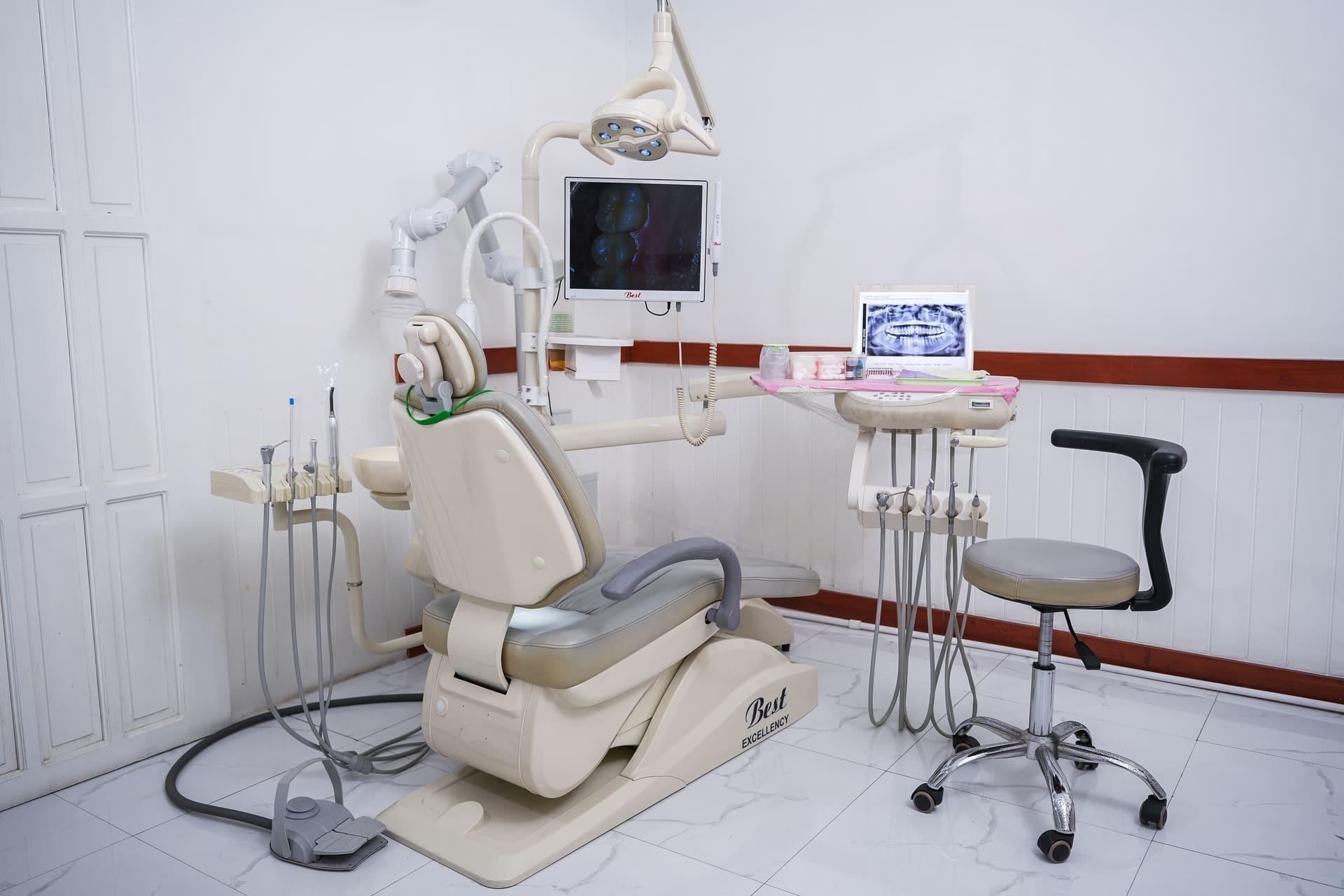 Modern treatment room with dental chair and equipment