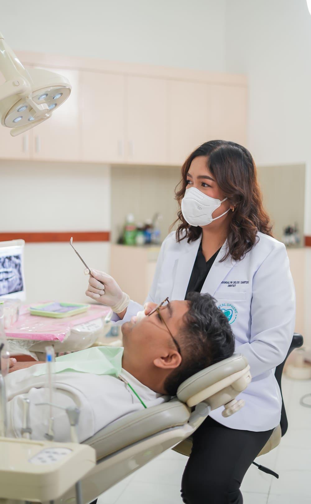 Dentist treating a relaxed patient in the chair