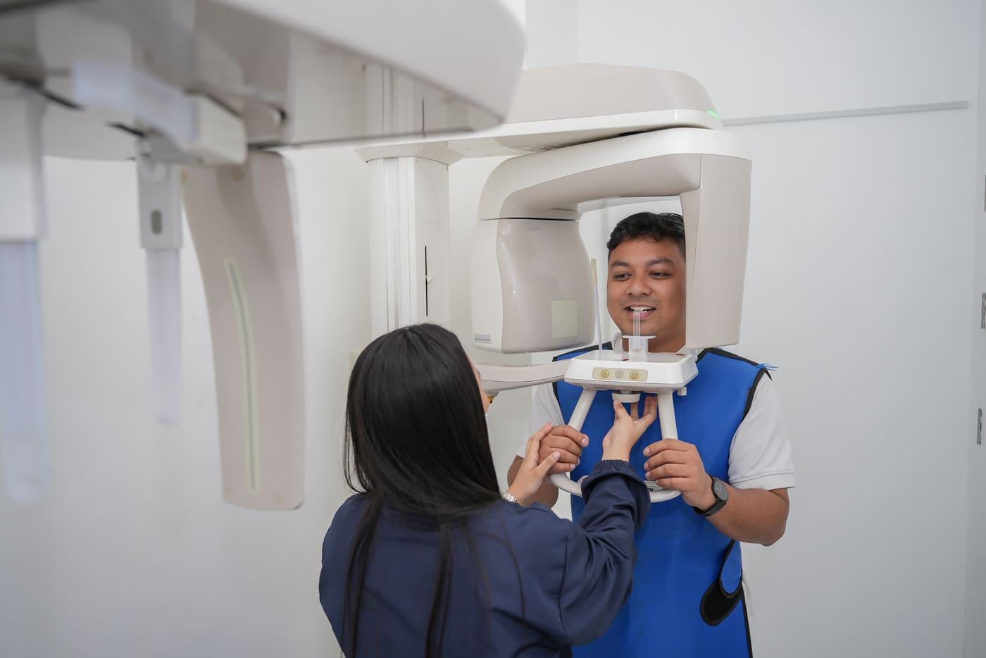 Patient having a panoramic X-ray taken at Dental Sphere